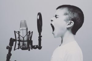 a kid is shouting on the microphone